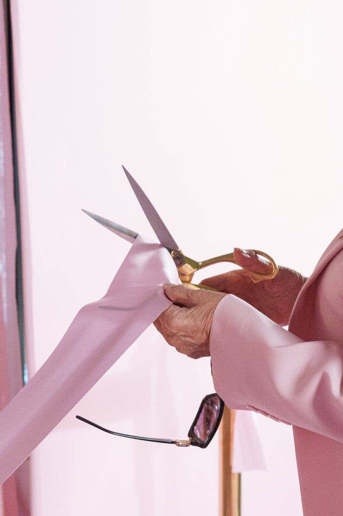 hand cutting pink ribbon