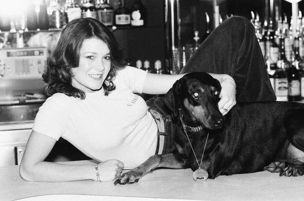Lisa Vanderpump in top posing with doberman pinscher during Killer's Moon photo-call 