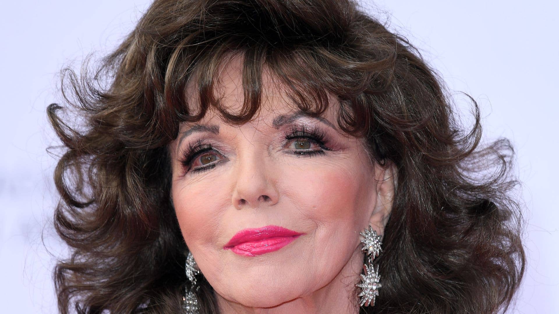 Dame Joan Collins in silver sequin dress