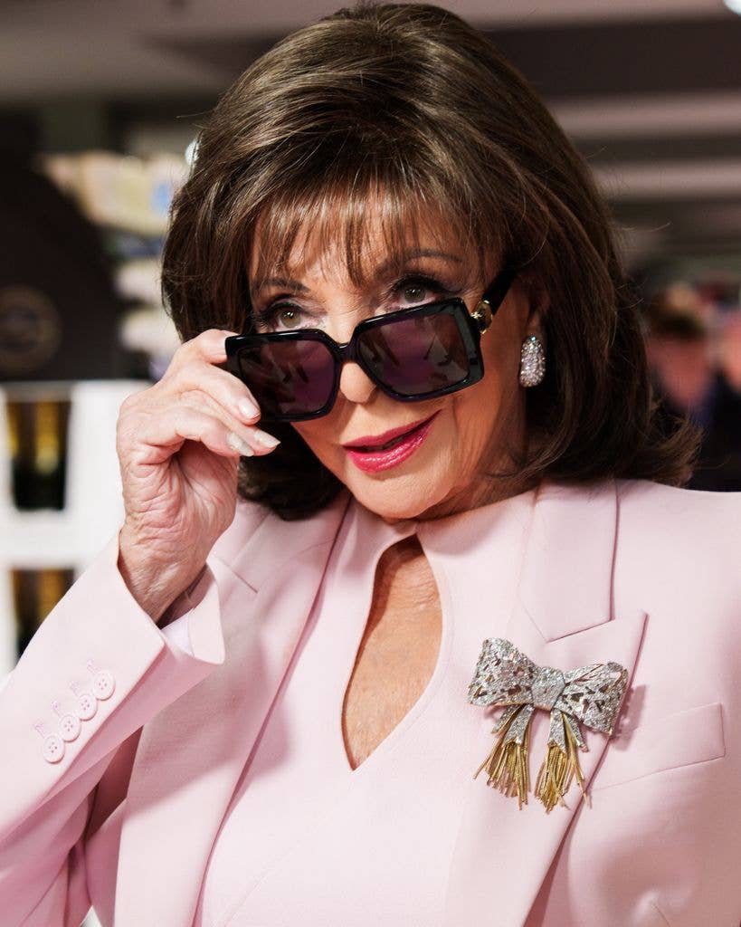 joan collins in pink suit and sunglasses