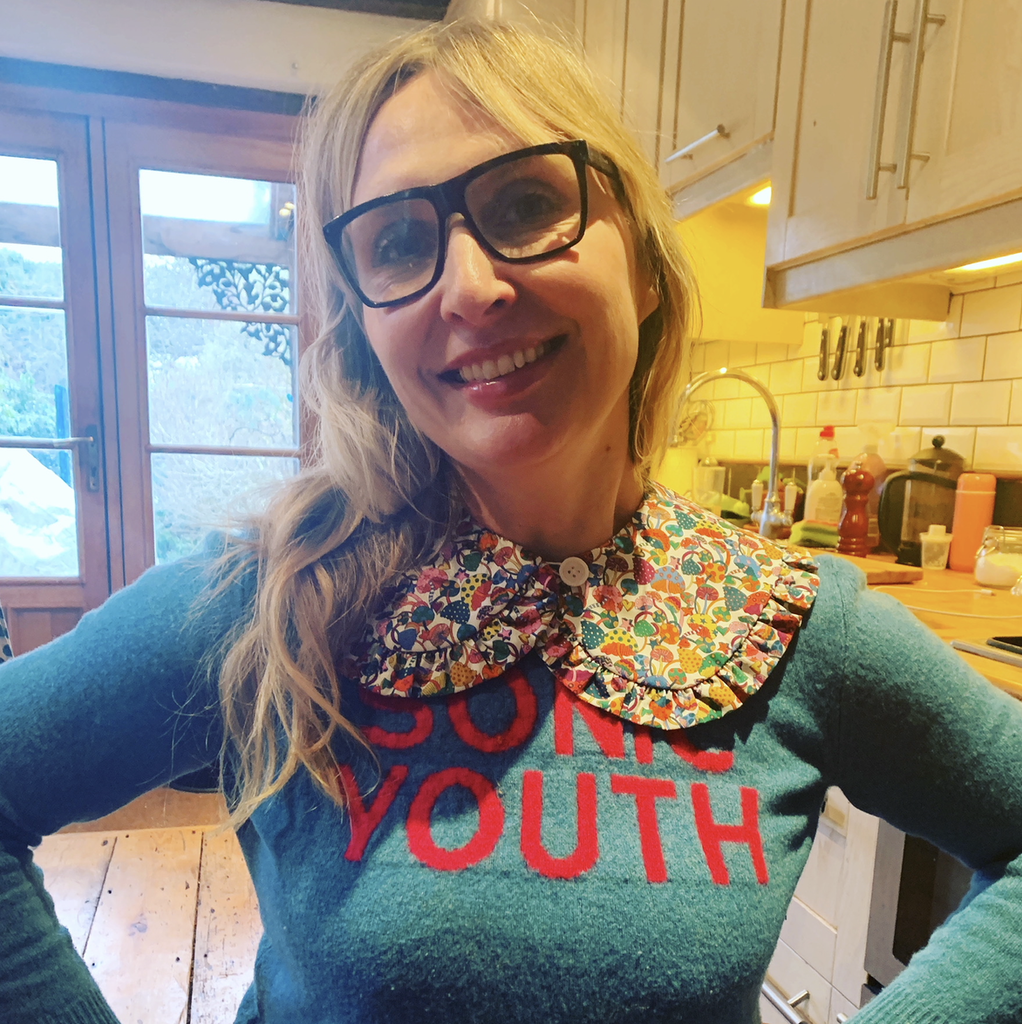 Journalist Anniki Sommerville smiling in a green Sonic Youth jumper